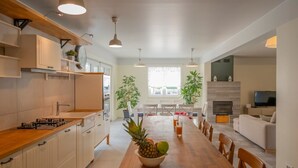 Una cocina moderna con armarios de madera, una isla central e iluminación colgante.