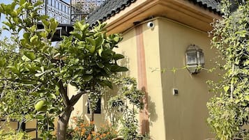 A building with a tiled roof and a balcony with a wrought iron railing.