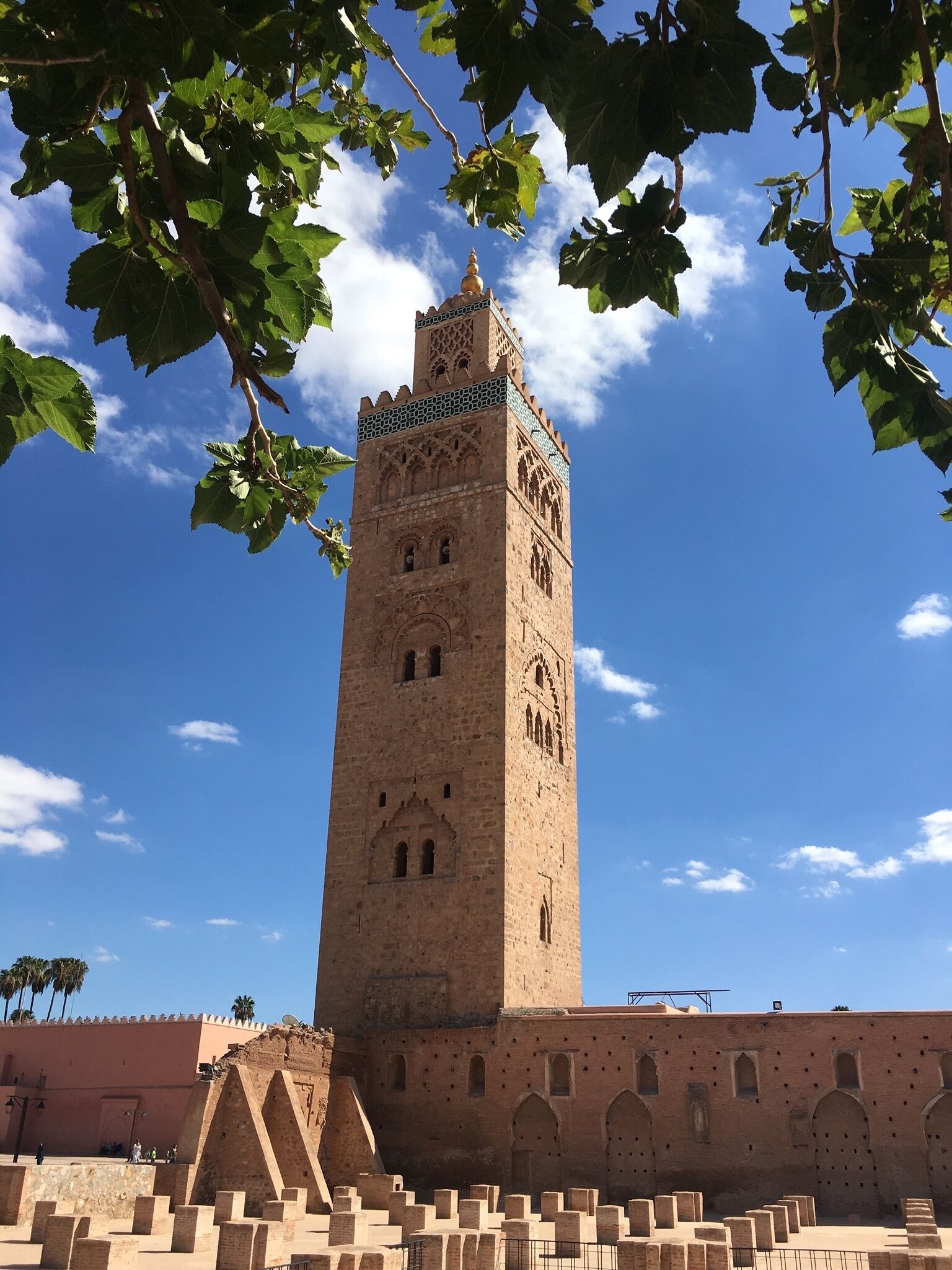 A tall, historic tower with intricate architectural details and a clear blue sky in the background.