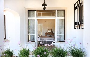 A bedroom with a bed, a dresser, and a window with curtains. - Jacuzzi Apartment (Lagos)