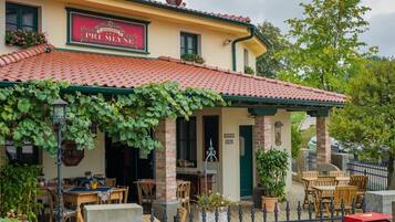 A traditional building with a red-tiled roof and a sign that reads "Haramia Pri Mlyne Boutique Hotel & Restaurant".