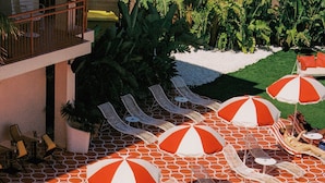 A pool area with lounge chairs and umbrellas. - Romeos Ibiza - Adults Only (Sant Josep de sa Talaia)