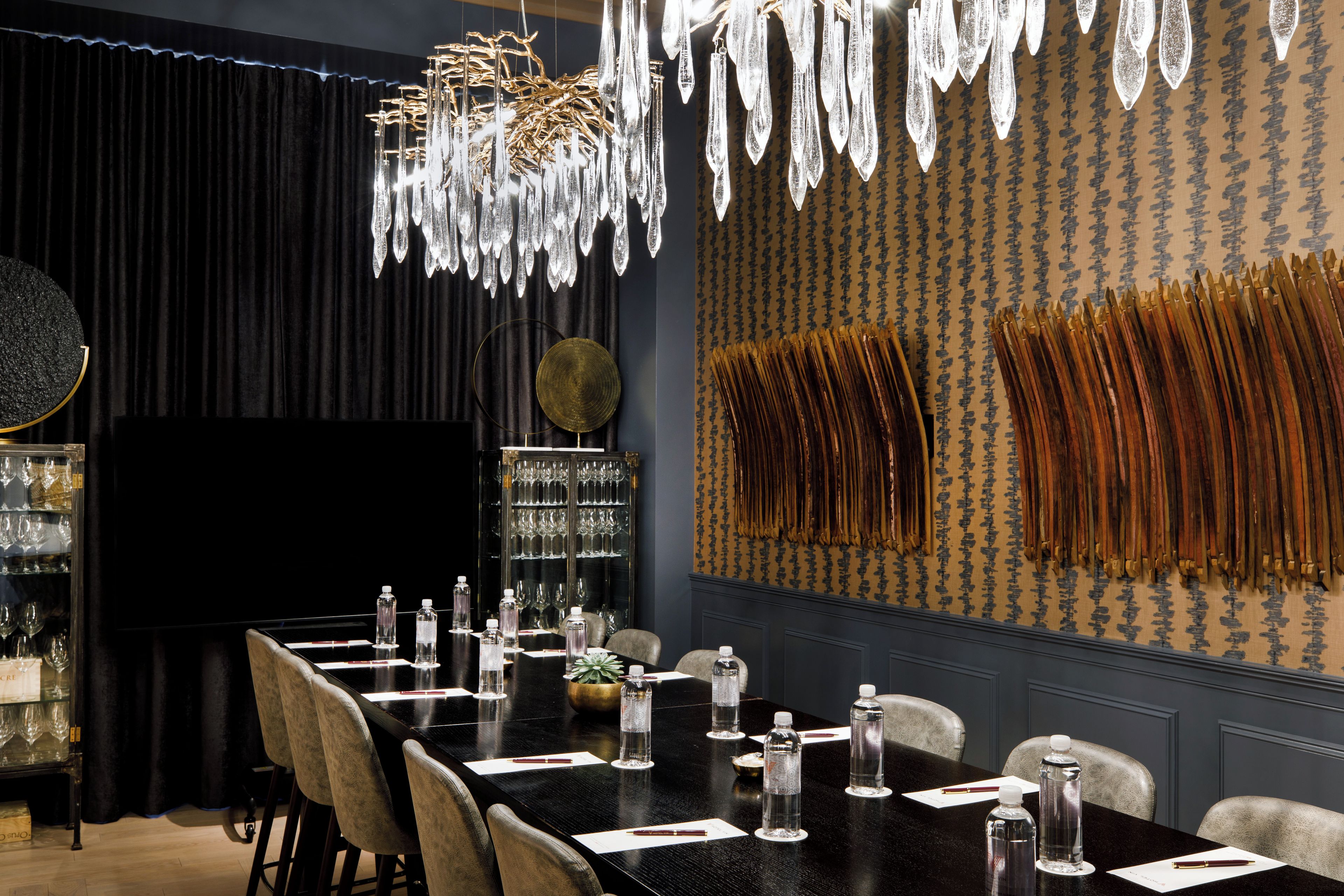 A conference room with a long table, chairs, and a chandelier.