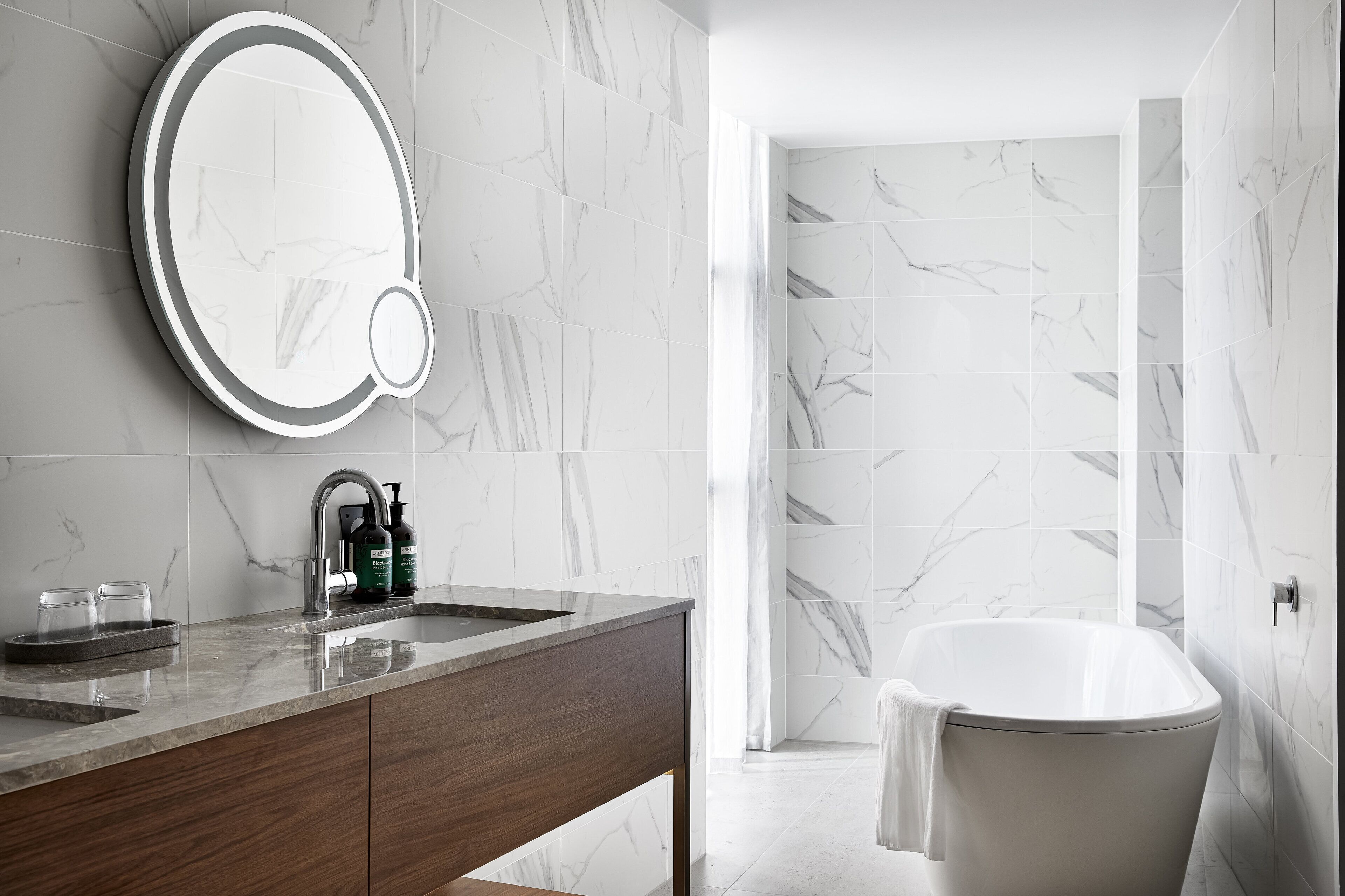 junior suite, 1 king bed, city view | bathroom | designer toiletries, hair dryer, bathrobes, slippers