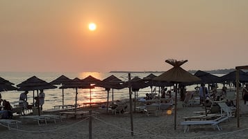 On the beach, sun-loungers