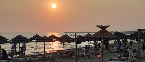 On the beach, sun-loungers