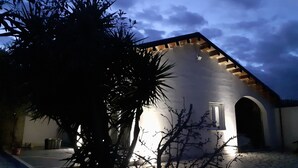 A building with a sloped roof and a single visible window.