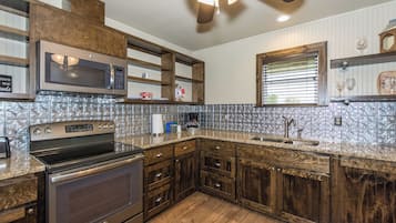 Fridge, microwave, coffee/tea maker, cookware/dishes/utensils