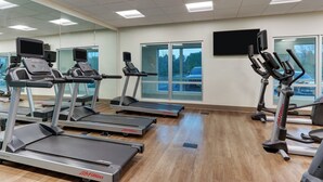 A gym with treadmills, ellipticals, and exercise bikes. - Holiday Inn Express & Suites Middletown - Goshen by IHG (Middletown)