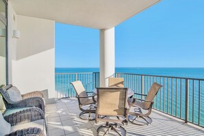 Enjoy the ocean view from this balcony with a comfortable seating area.
