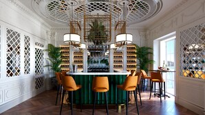 A bar area with a green bar counter, multiple chairs, and a ceiling with intricate lattice design. - Hotel Villa Favorita - Adults Only (San Sebastián)
