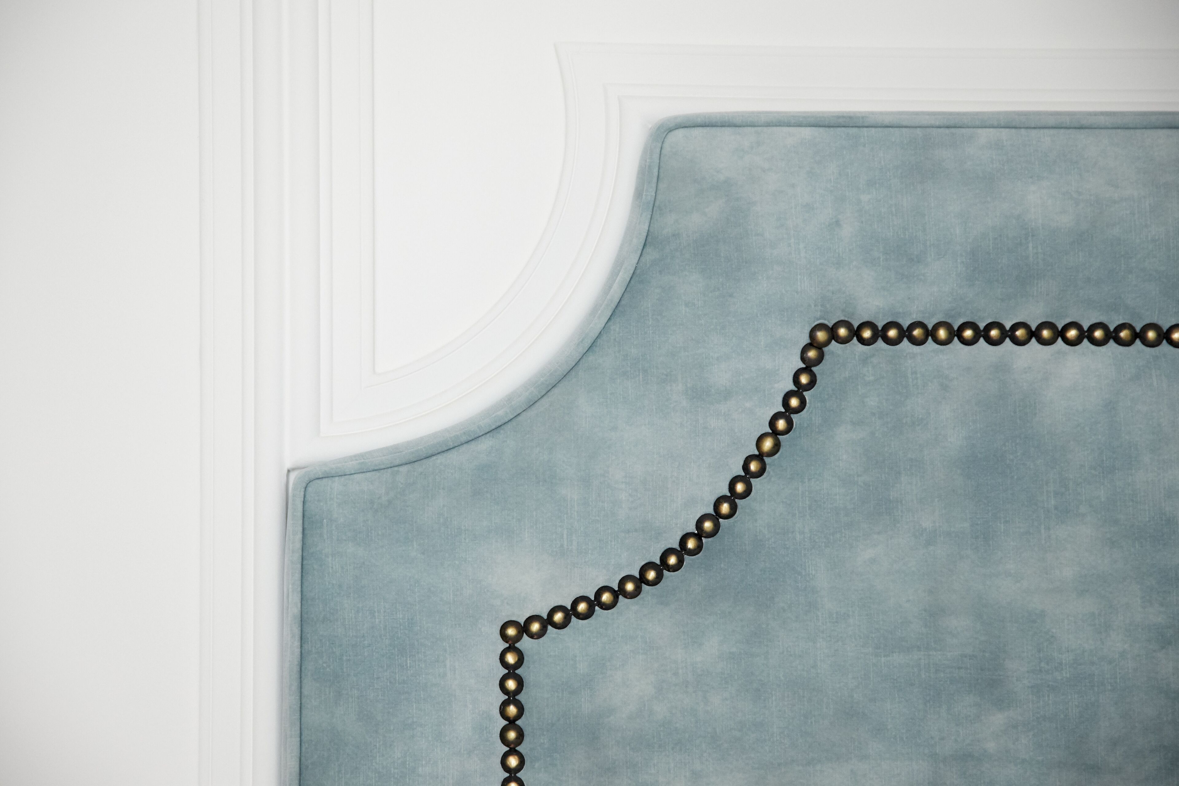 A close-up of a textured fabric with a beaded border.