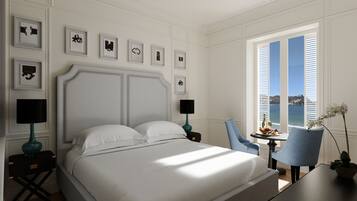A neatly arranged bedroom with a large bed, two bedside tables with lamps, a chair, and a view of the sea through a window with shutters.