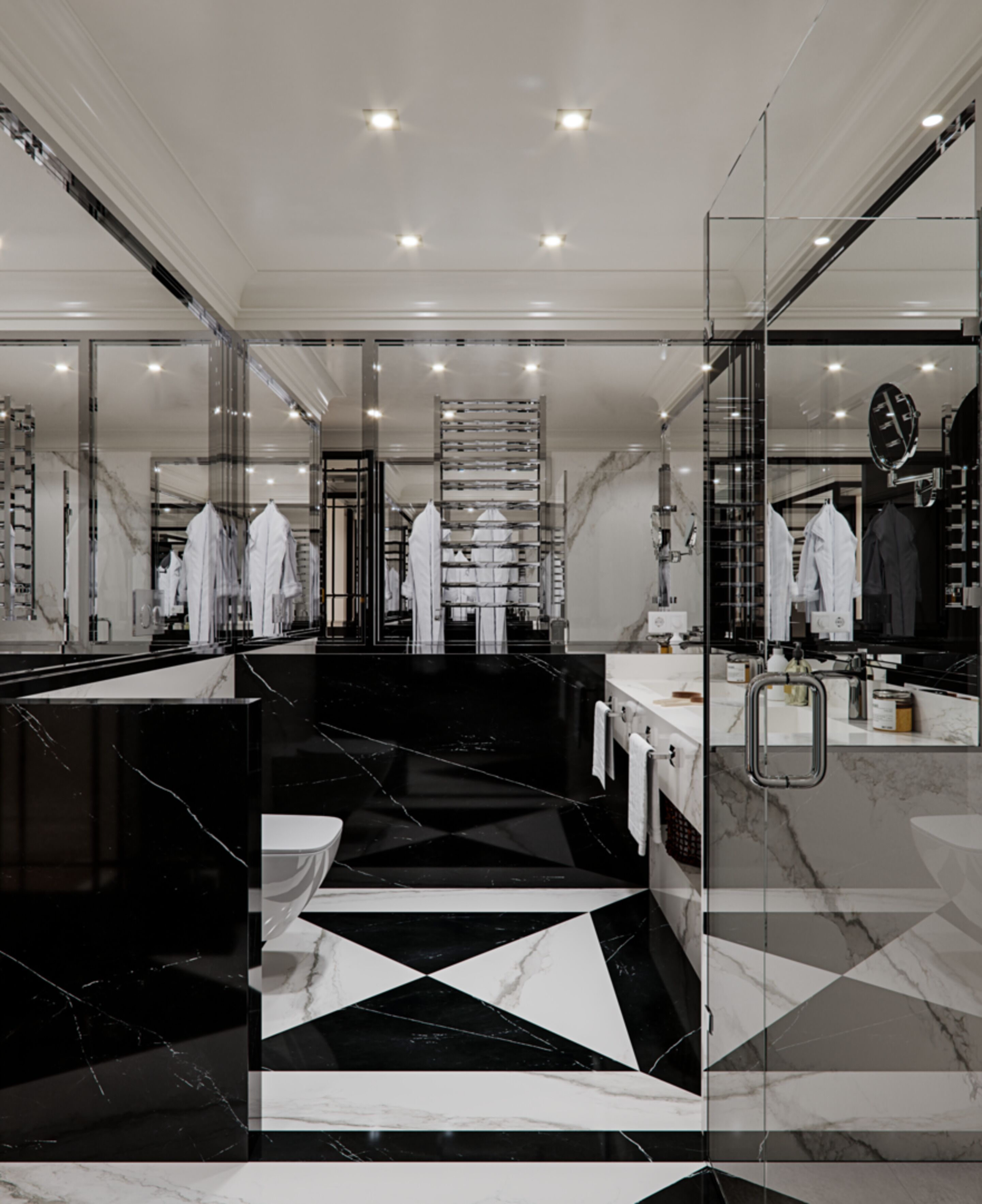 A modern bathroom with a black and white marble floor, a glass shower enclosure, and a large mirror.