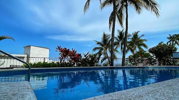 Outdoor pool, pool umbrellas, sun loungers