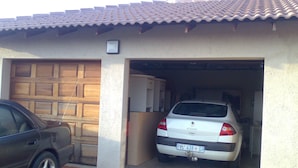 A garage with a car parked inside. - Fourie Street Guesthouse (Mogalakwena)