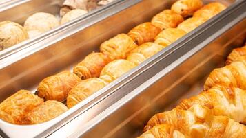 A display of assorted pastries in a bakery section.