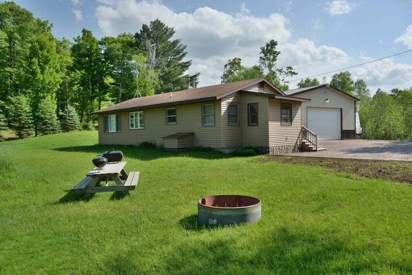 Inviting Grassy Yard with Firepit