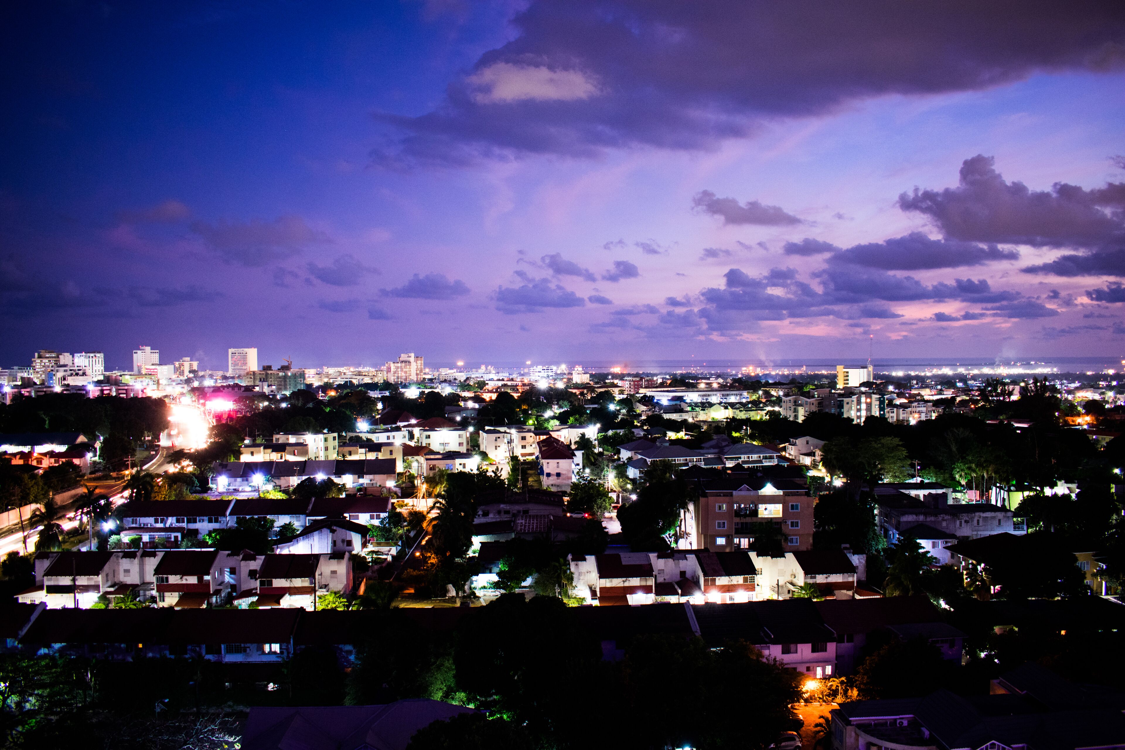 A nighttime cityscape with illuminated buildings and streets.