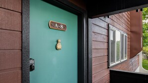 A teal door with a wooden plaque reading "A-8" and a small decorative item above it. - Outpost: Gros Ventre A8 - Hot Tub Access (Teton Village)