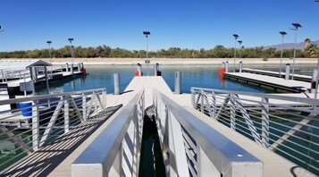 A marina with docks, solar-powered lights, and calm water.