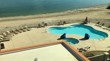 Relax by the freeform pool surrounded by lounge chairs and enjoy scenic ocean views.