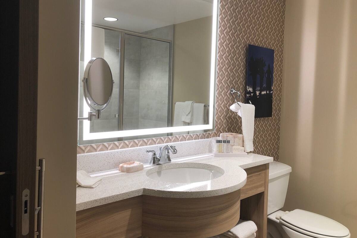 designer toiletries, hair dryer, towels, soap