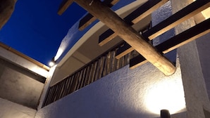 A building with a white exterior, wooden beams, and a balcony. - Sentro Suites Siargao (General Luna)