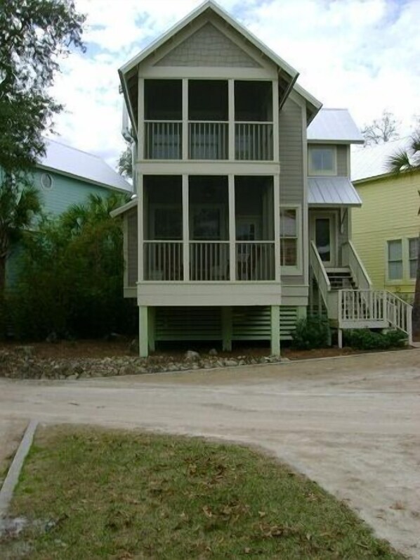 A two-story building with a balcony on the upper floor, a front porch, and a staircase leading to the upper level. - Steinhatchee Landing Resort-Serendipity #48-Dog Friendly-**THIRD NIGHT FREE** (Steinhatchee)