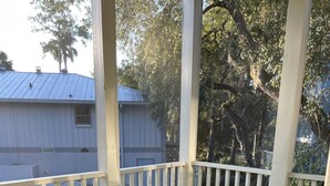 A covered outdoor patio with a table and chairs. - Steinhatchee Landing Resort-Serendipity #48-Dog Friendly-**THIRD NIGHT FREE** (Steinhatchee)