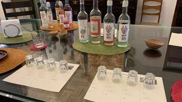 A dining table with multiple bottles and glasses, a menu, and a decorative bowl.