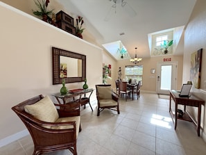 A spacious living area with a dining table, chairs, a sofa, and a TV. - * Your Peaceful Florida Escape Awaits! * (Rotonda West)