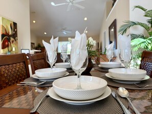 A dining table set with white plates, clear glassware, and folded napkins. - * Your Peaceful Florida Escape Awaits! * (Rotonda West)