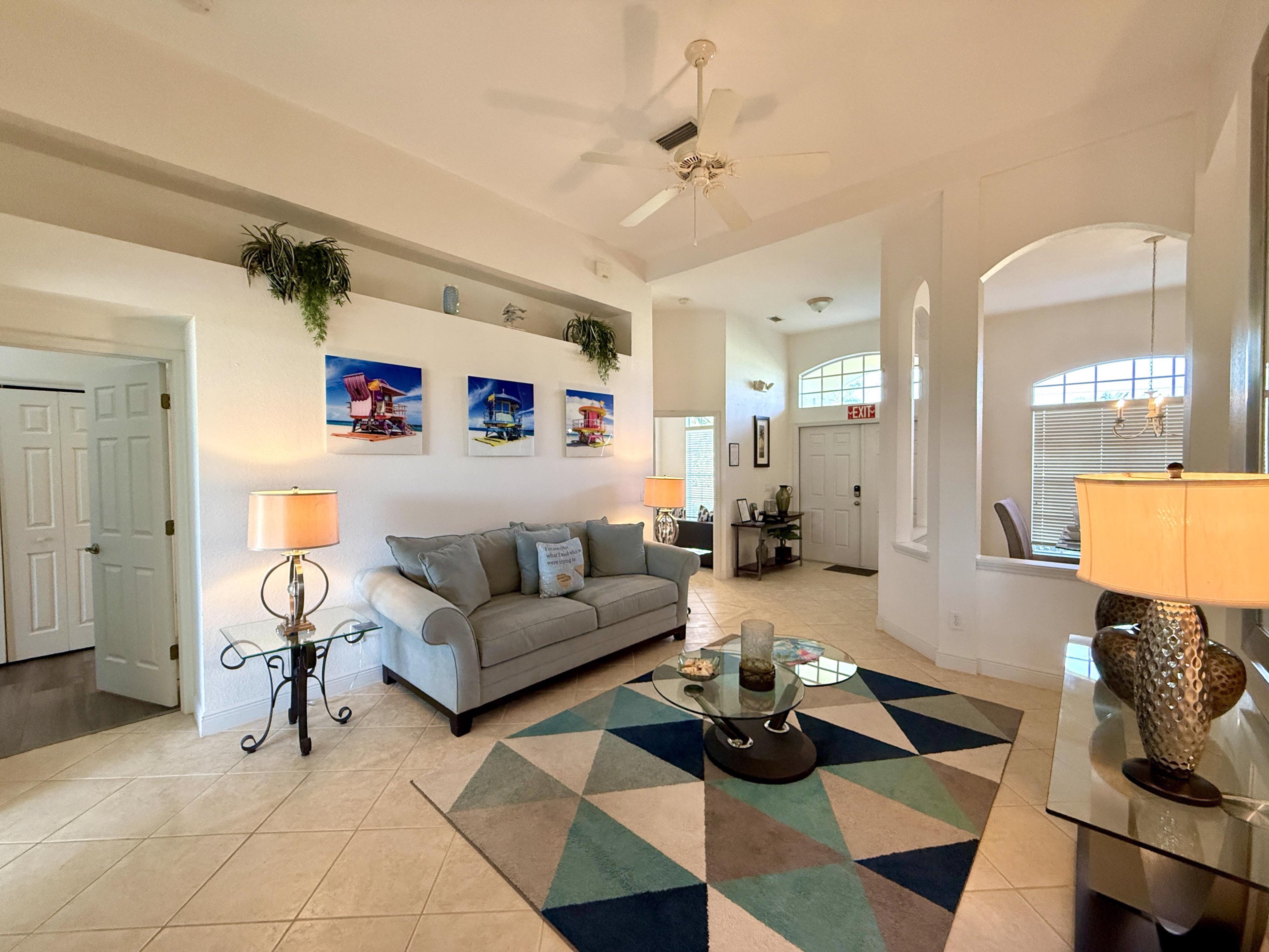 A spacious living room with a sofa, coffee table, and decorative items.