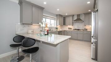 Enjoy casual dining and cooking in this well-equipped kitchen with a central island and ample storage.