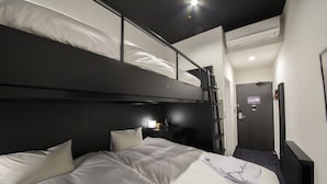 A bunk bed room with a desk and a door. - HOTEL TRAD Replay (Osaka)