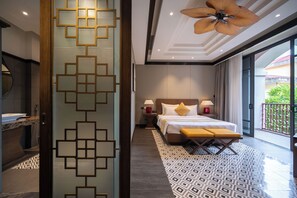 A modern hotel room with a large bed, bedside lamps, a wooden headboard, and a balcony with a view. - Senna Hue Hotel (Hue)