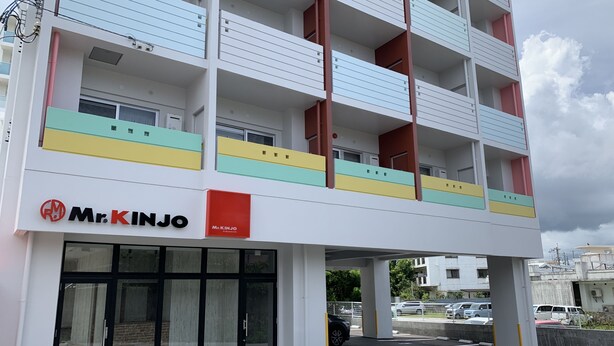 A multi-story building with a Mr. KINJO store on the ground floor. - Mr.KINJO in Rycom Kitanakagusuku (Kitanakagusuku)