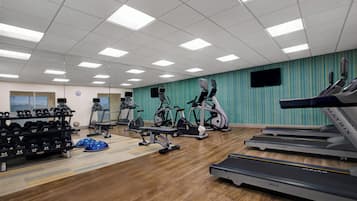 A gym with treadmills, stationary bikes, and weight machines.