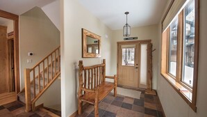 A hallway with a wooden bench, a mirror, and a door labeled "Treaty". - Walk to downtown Winter Park with views of Parry Peak (Winter Park)