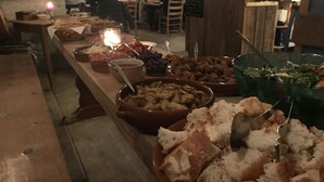 A buffet table with various food items and a candle. - Skeikampen Appartement (Gausdal)