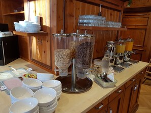 A buffet setup with various food dispensers and a coffee station. - Gasthof Kampenwand Aschau (Aschau im Chiemgau)
