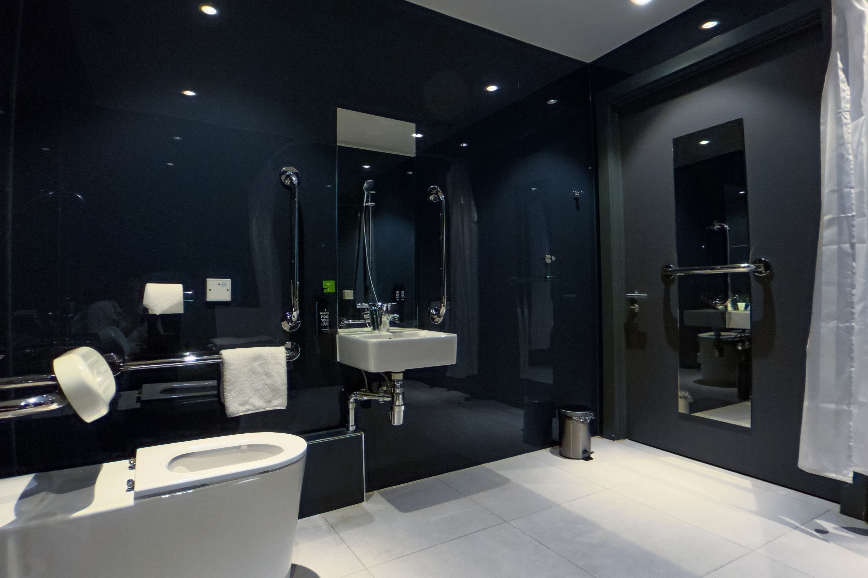 A modern bathroom with a toilet, sink, and bathtub.
