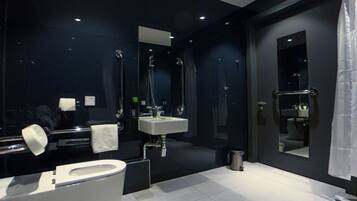 A modern bathroom with a toilet, sink, and bathtub.