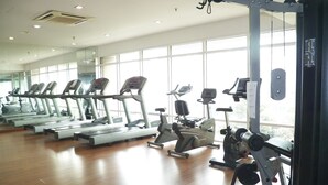 A gym with treadmills, elliptical machines, and weight equipment. - Maytower Apartment (Kuala Lumpur)