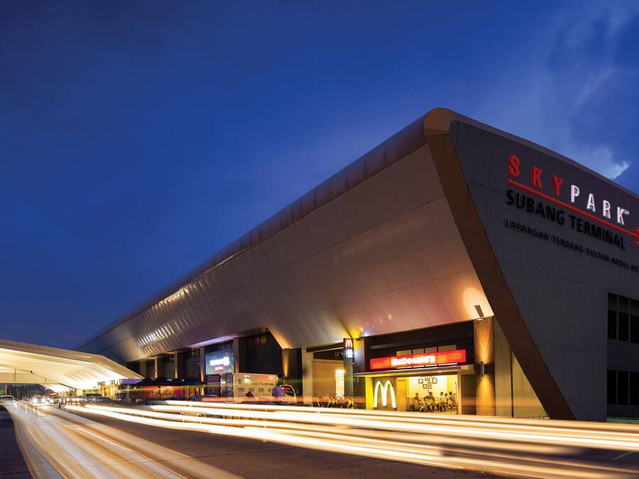 A modern building with the sign 'SKY PARK SUBANG TERMINAL' and a McDonald's restaurant.