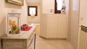 Un baño con tocador, espejo, inodoro y zona de ducha.
