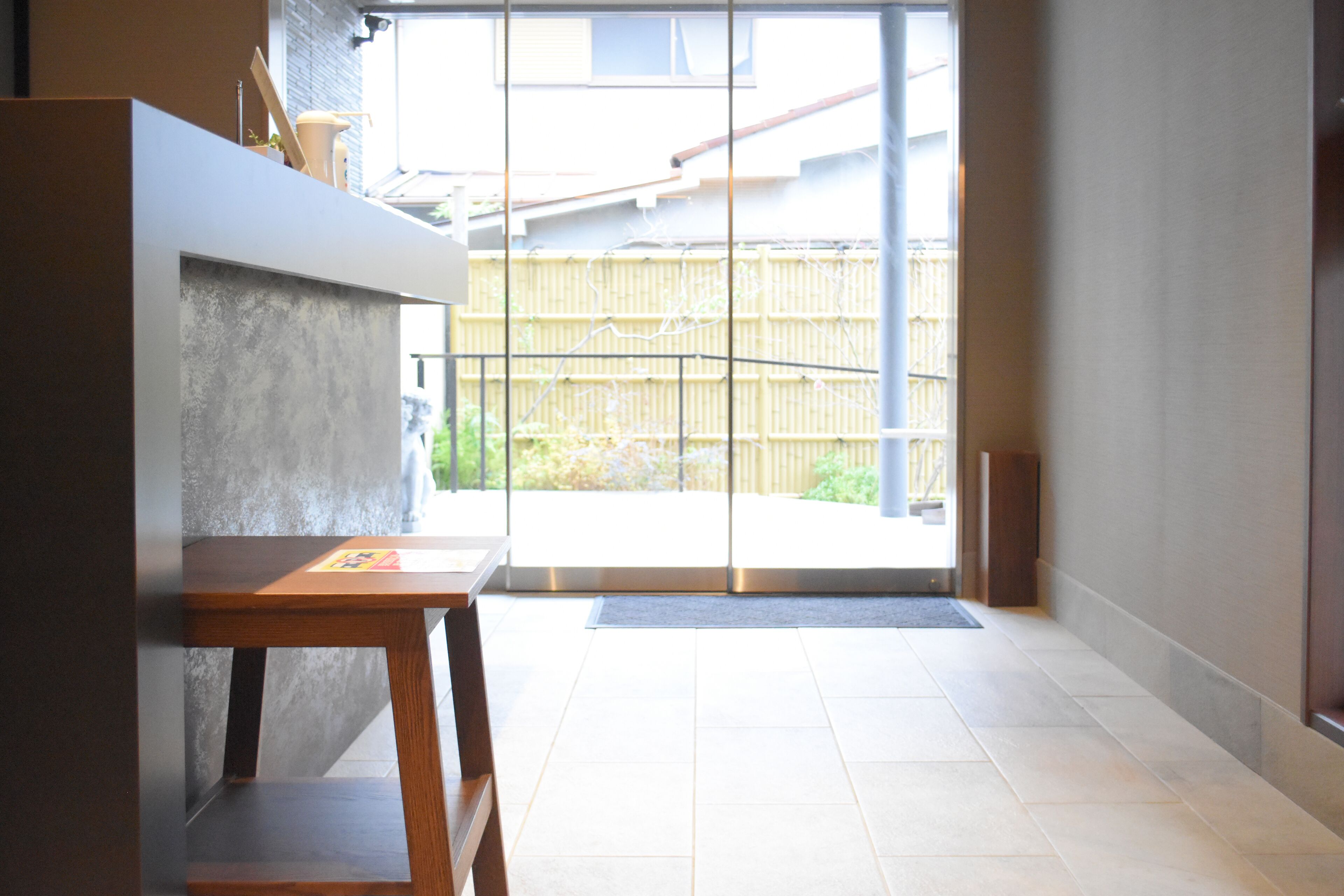 A modern interior with a wooden table and a concrete accent wall.