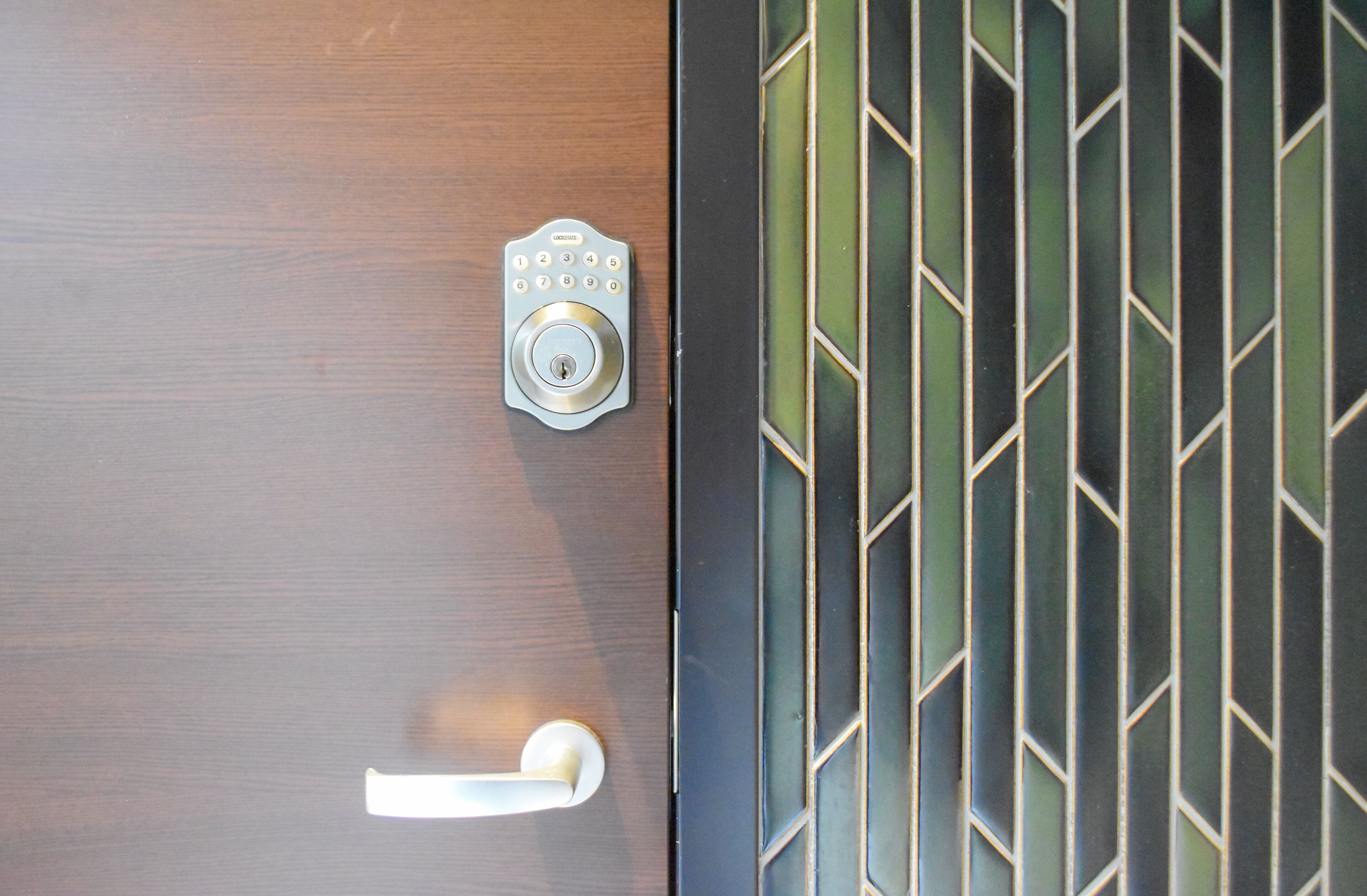 A door with a keypad lock and a handle.