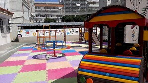 A colorful play area with a train ride and climbing structures. - Gohouse - Laranjeiras 116 (Rio de Janeiro)